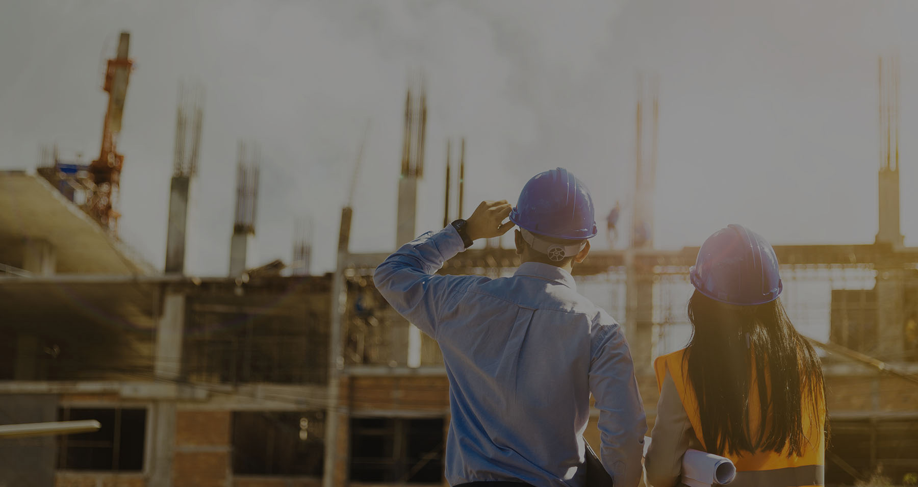 Construction-workers-standing-on-site-and-looking-at-the-building